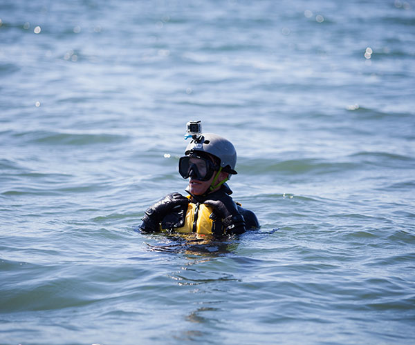 Dive Team member in the ocean, with his head out of water.