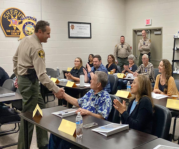Sheriff Parkinson shaking hands with a Citizen Academy participant during a session.