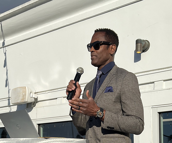 Commander Keith Scott speaking into a microphone.